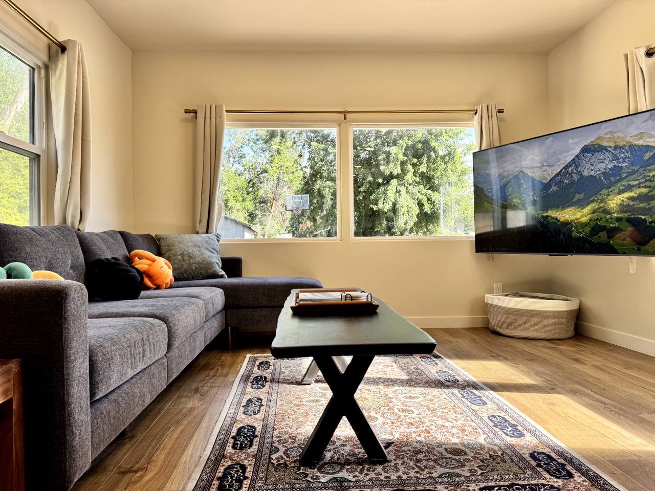 Living room from the kitchen side, sectional facing the wall-mounted TV