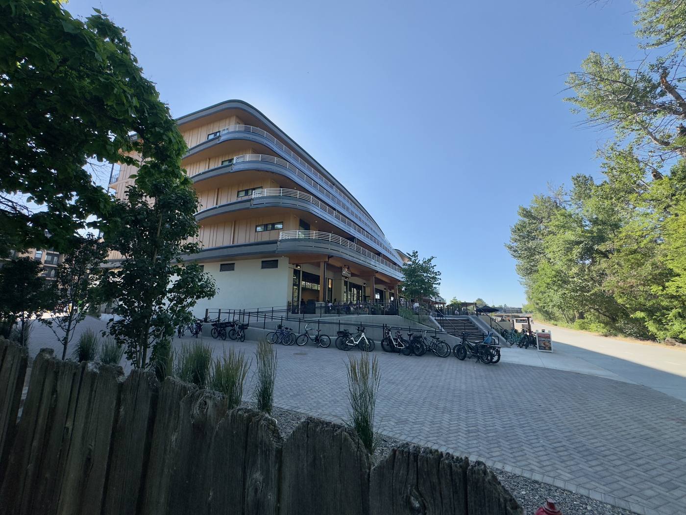 The Boardwalk from the Greenbelt in daylight, bikes racked along the frontage