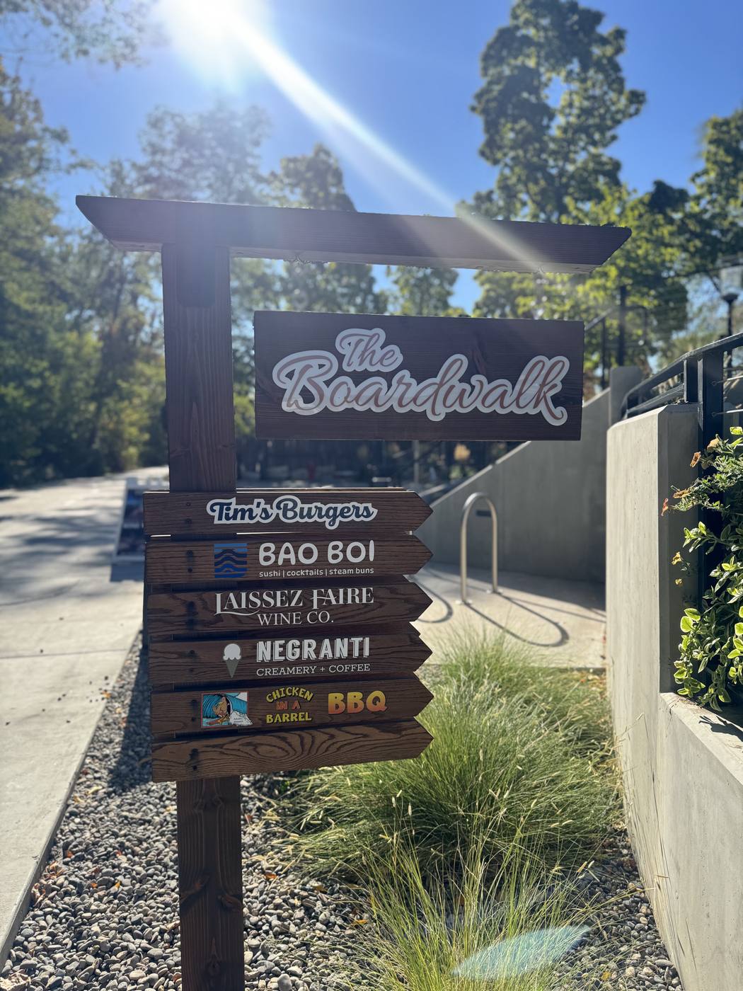 The Boardwalk sign listing Tim's Burgers, Bao Boi, Laissez Faire Wine Co., Negranti Creamery and Chicken in a Barrel BBQ