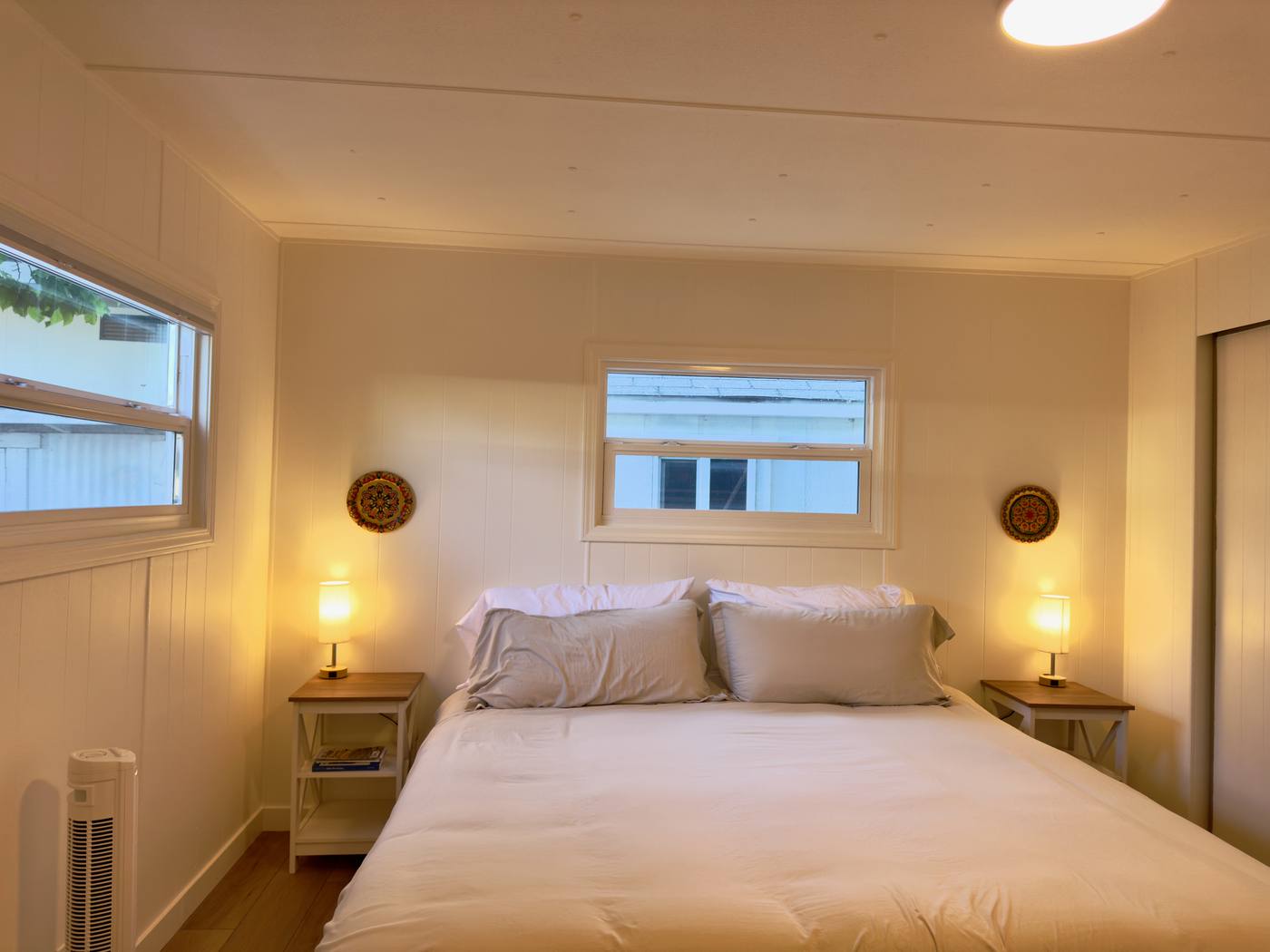 First bedroom with a king bed and reading lamps on both nightstands